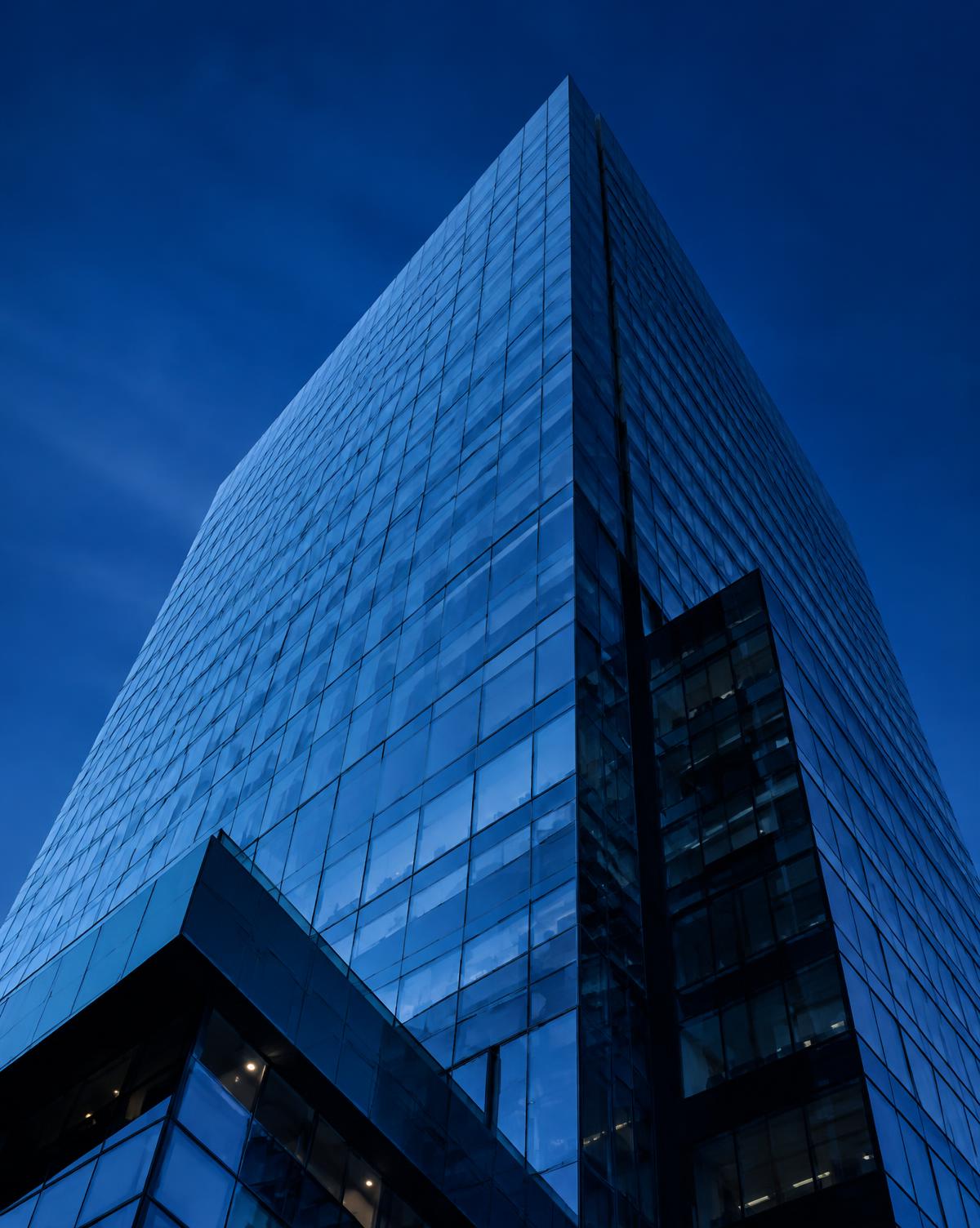 Glass and steel corporate tower at blue hour